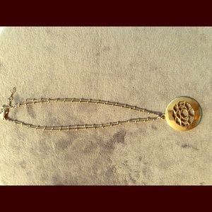 Gold necklace with gold floral pendant